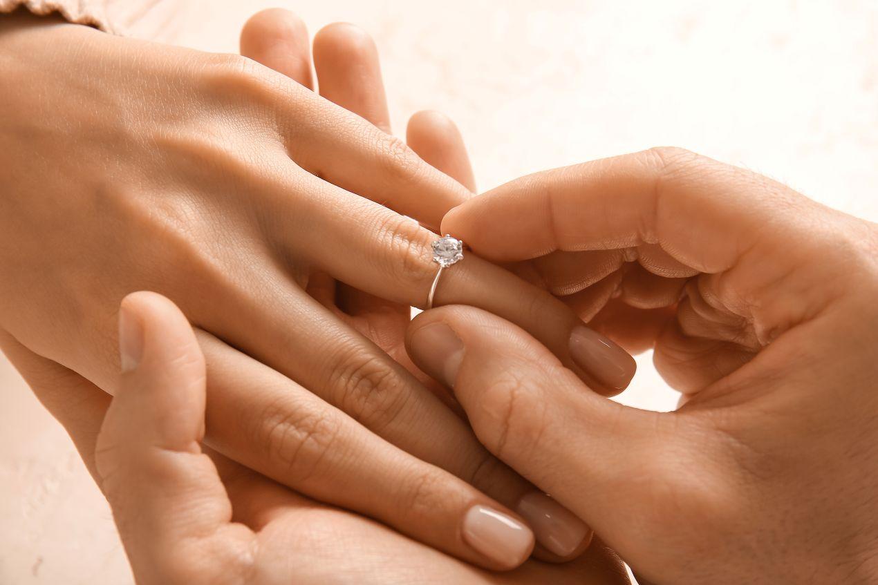Verlobungsringe Silber Nahaufnahme beim Anstecken des Rings an die Hand einer Frau